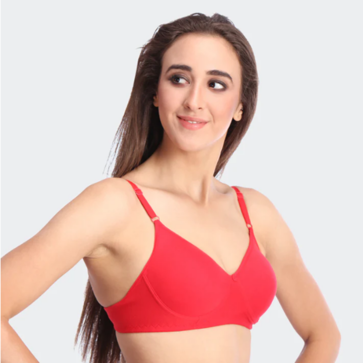 Woman wearing a red bra on a light gray background