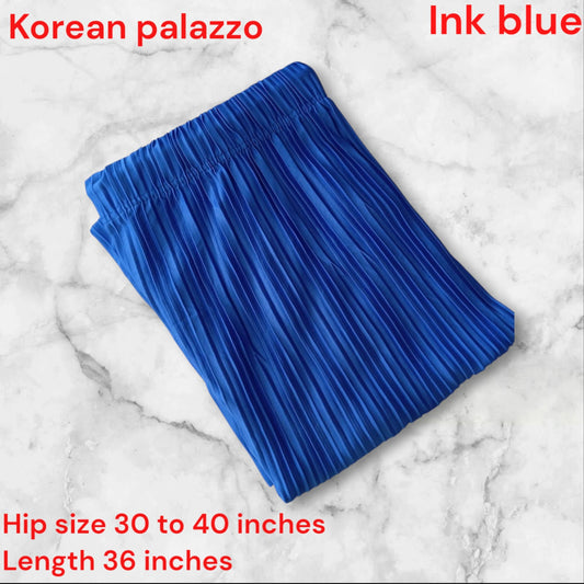 Blue pleated skirt on a marble background with text indicating color and size information.