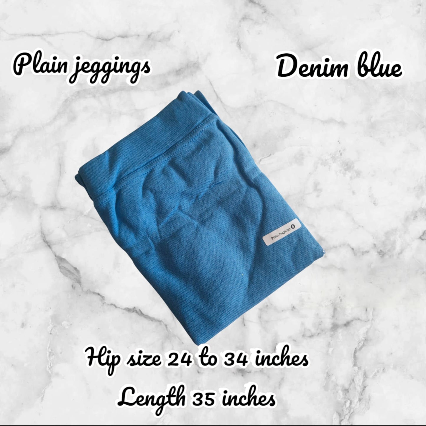 Folded blue jeggings on a marble background with text indicating color, size range, and dimensions.