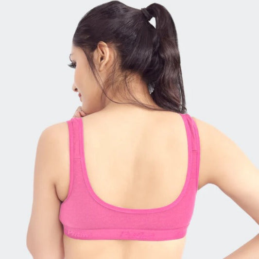 Person wearing a pink sports bra on a plain background