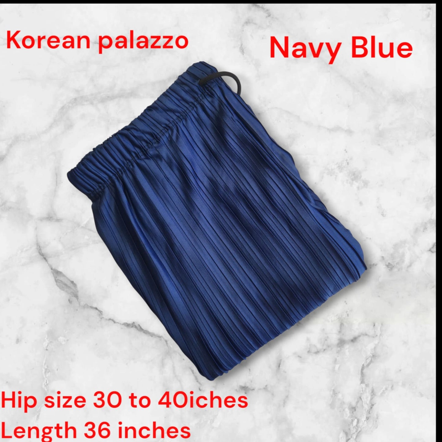 Navy blue palazzo pants on a marble background with text indicating size and length.