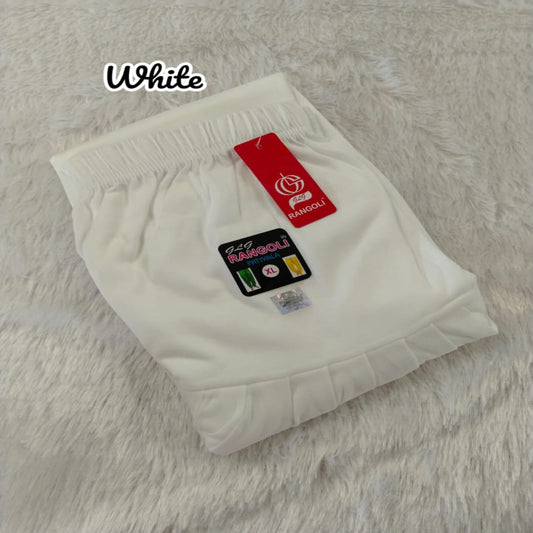 White baby shorts with a red tag on a textured surface