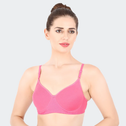 Woman wearing a pink bra against a light gray background