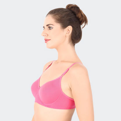 Woman wearing a pink bra against a light gray background