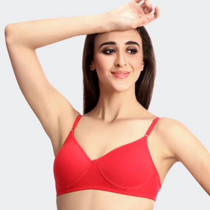 Woman wearing a red bra against a plain background