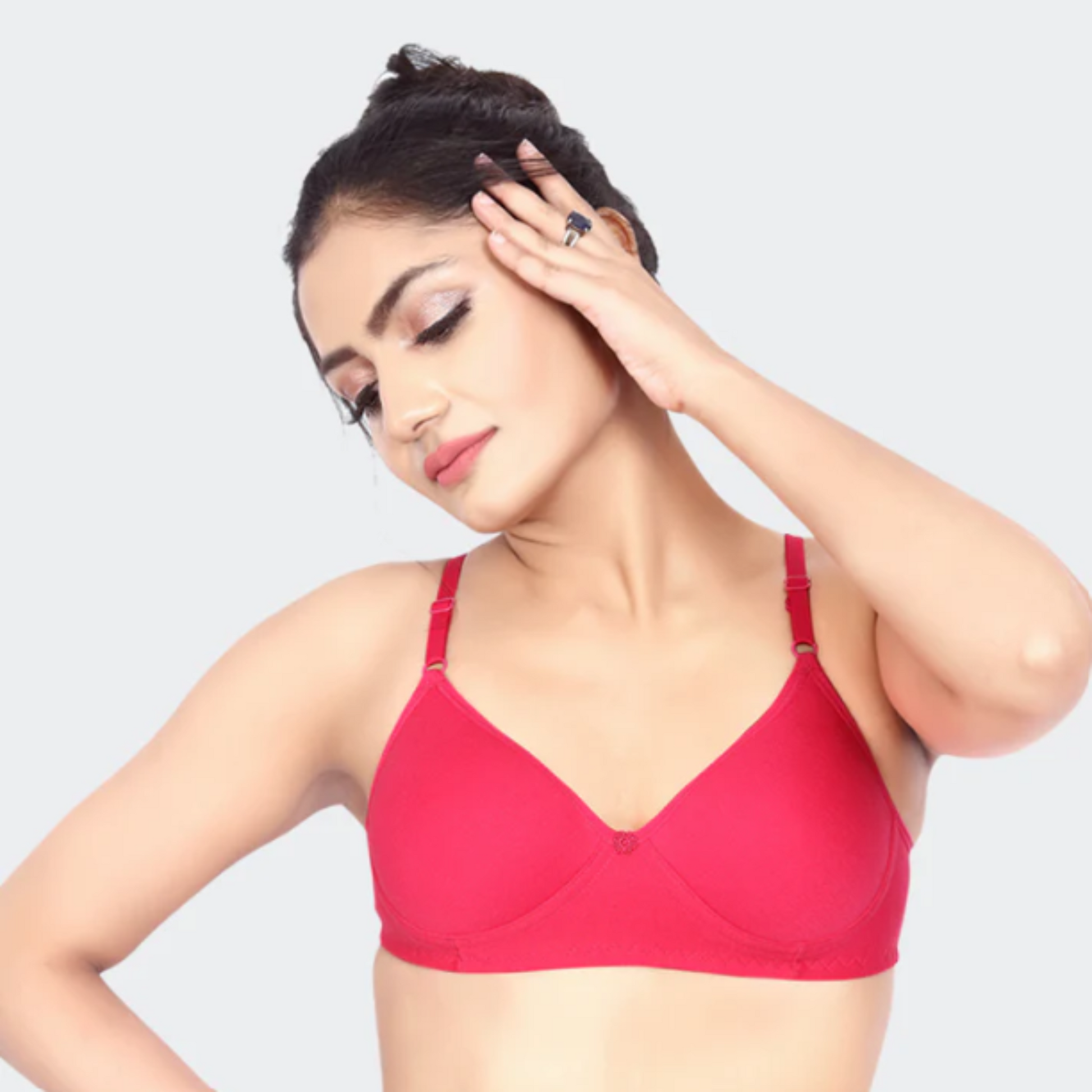 Woman wearing a red bra against a white background