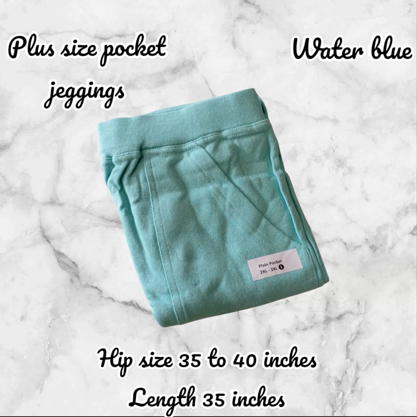 Folded teal jeggings on a marble surface with text describing size and color.