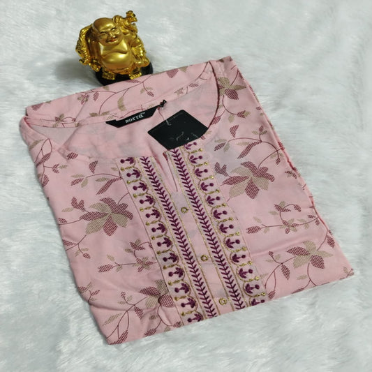 Folded pink garment with floral patterns on a white background