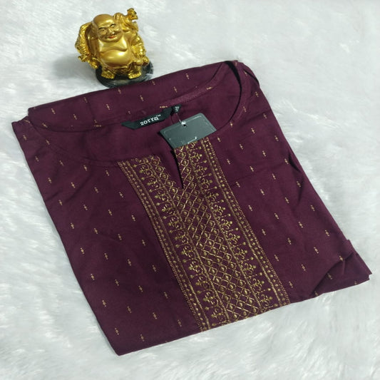 Maroon garment with gold embroidery on a white textured background