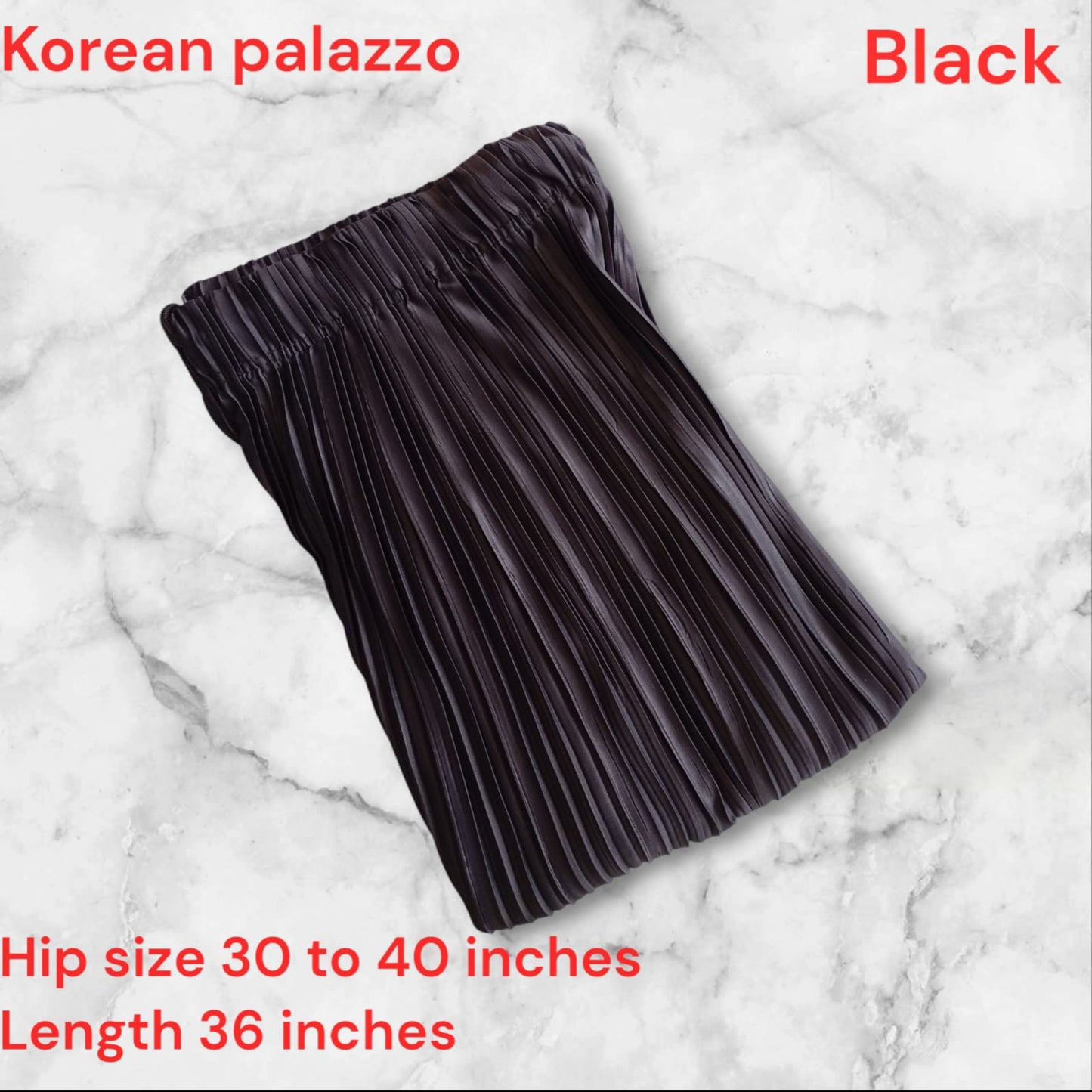 Black pleated skirt on a marble background with text about size and length.