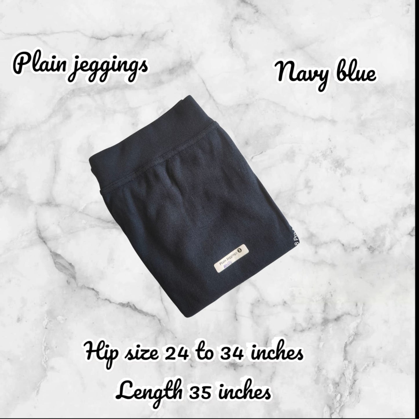 Navy blue jeggings on a marble background with text indicating size and length.