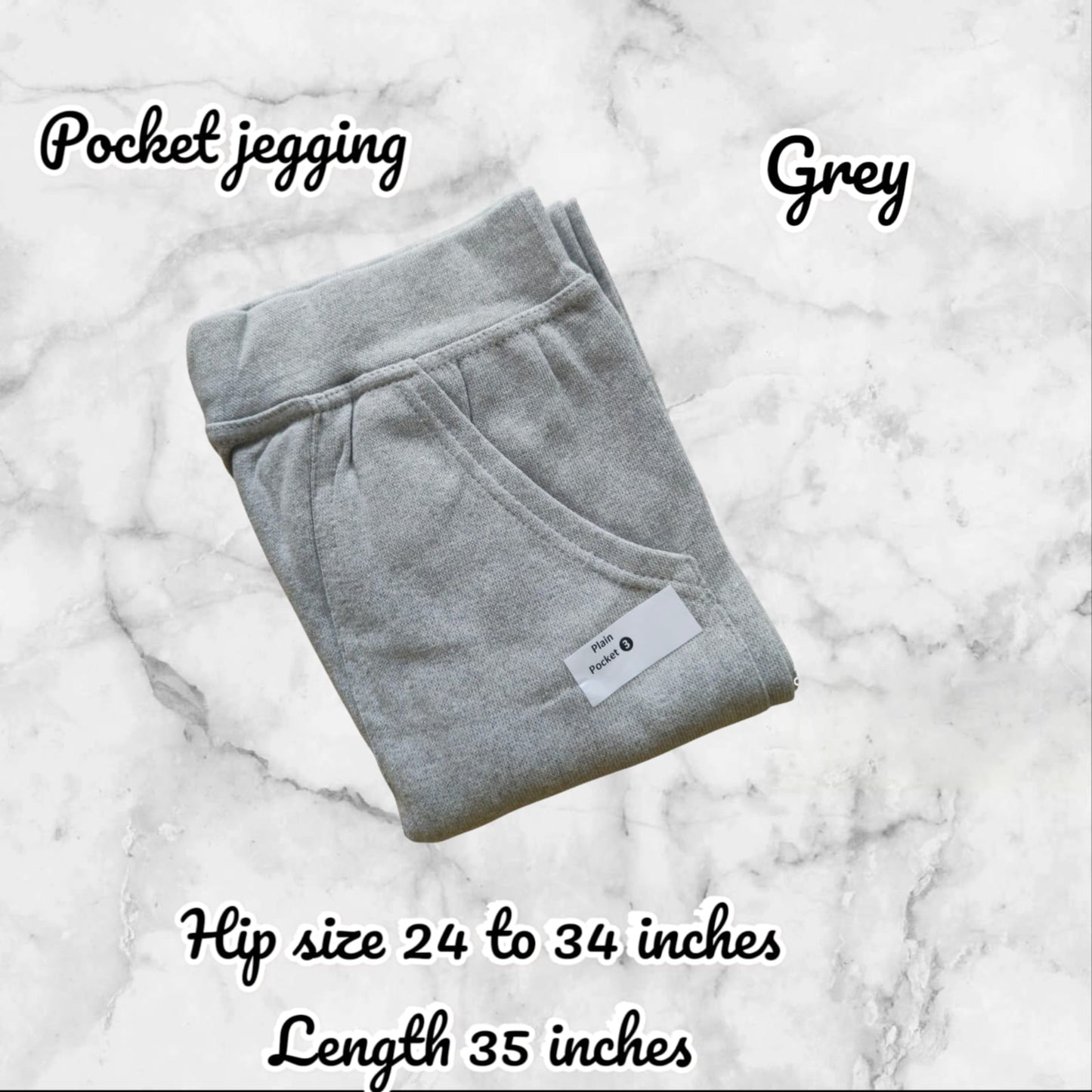 Folded gray pocket jegging on a marble surface with product details.