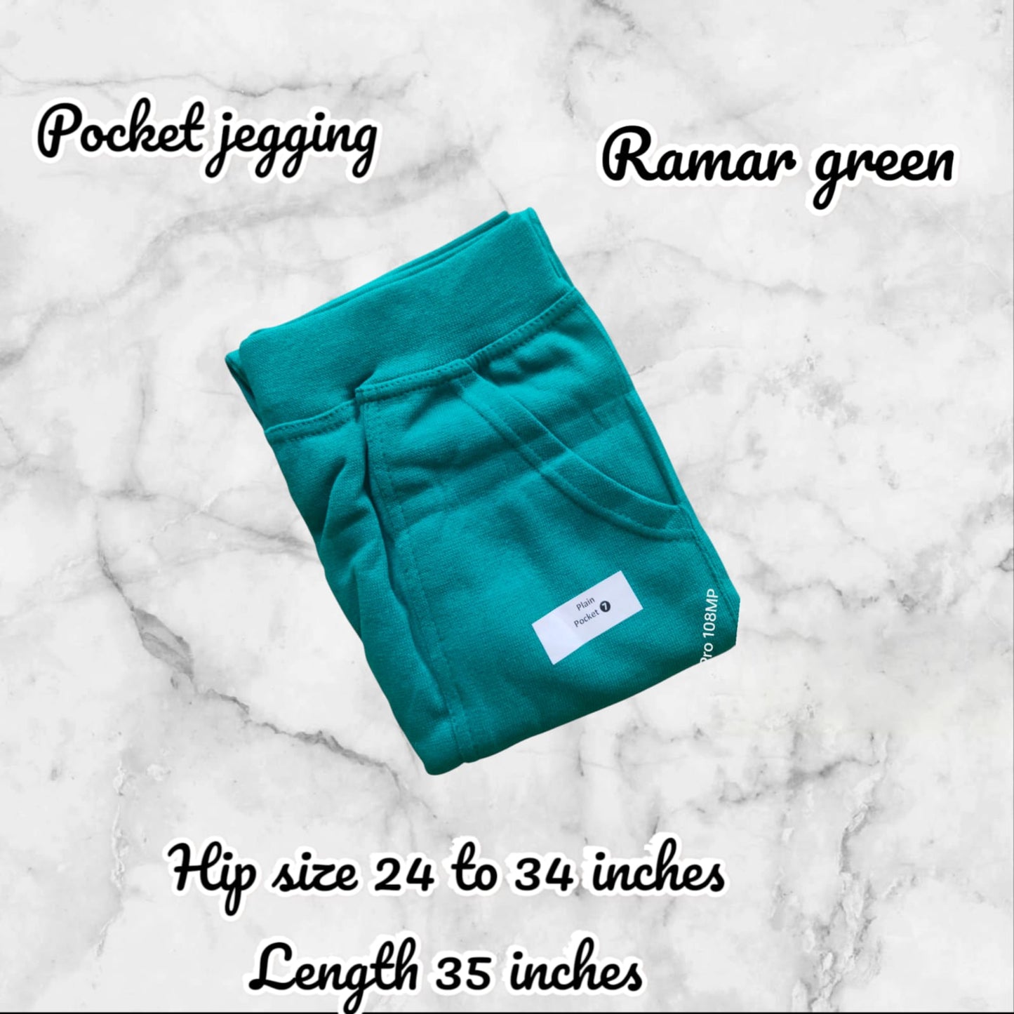 Teal pocket jegging on a marble background with product details.