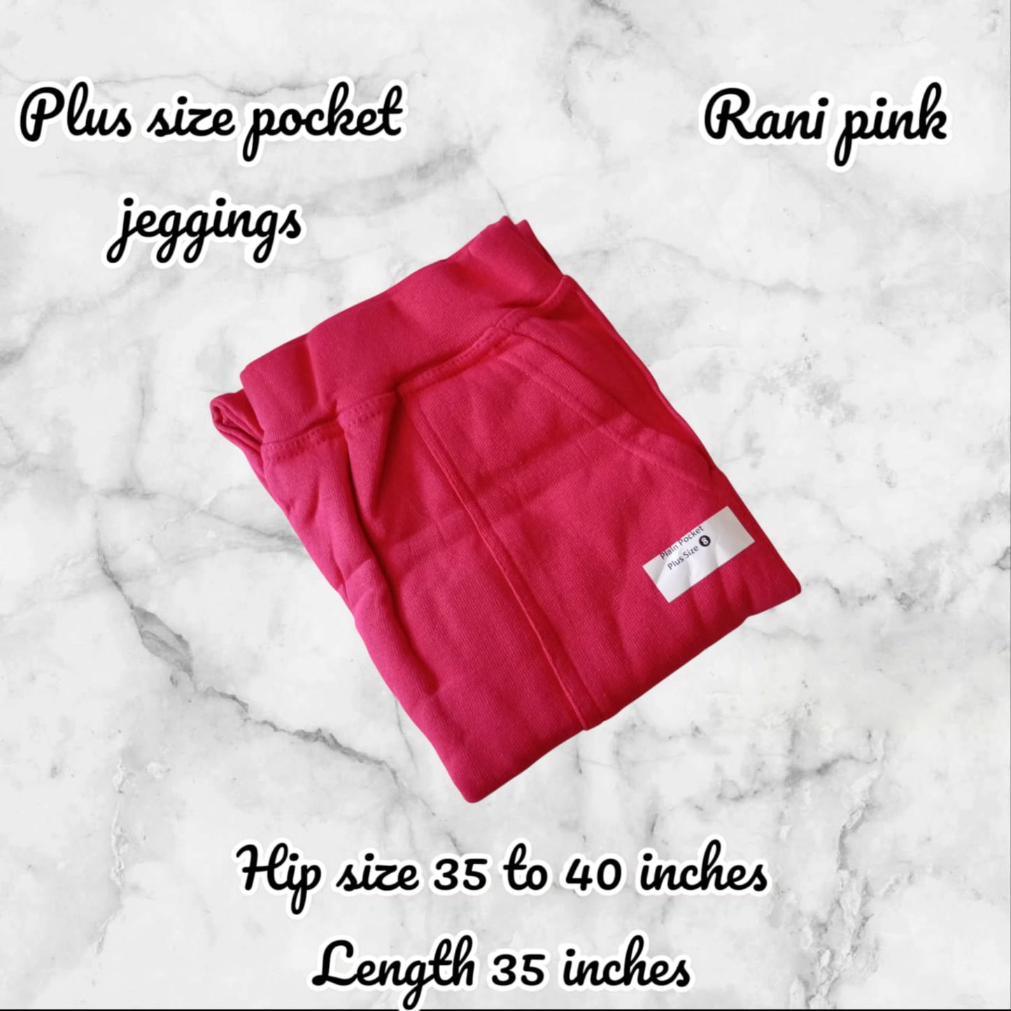 Folded pink plus size pocket jeggings on a marble background with product details.