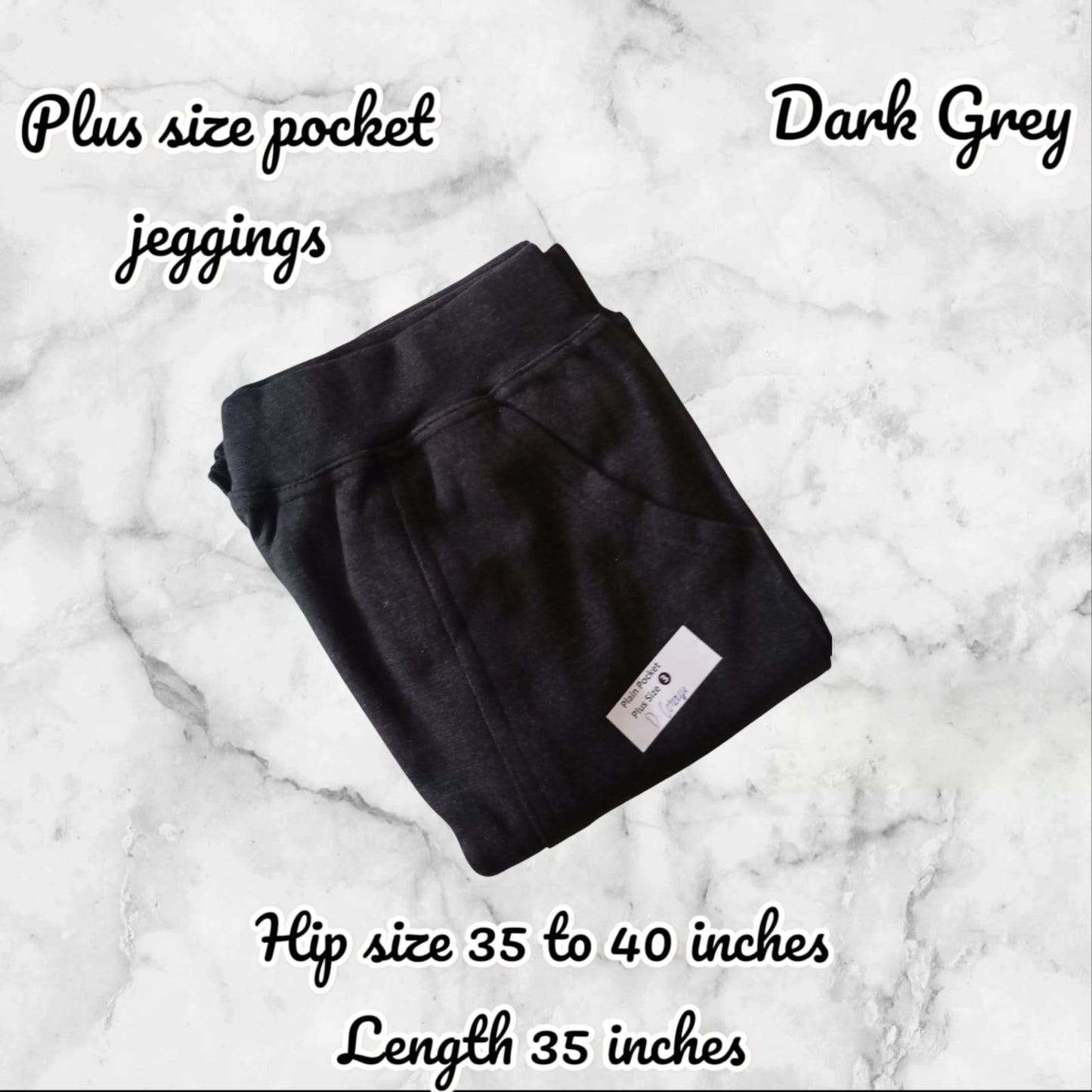 Dark grey plus size pocket jeggings on a marble background with text detailing size and length.