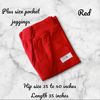 Folded red plus size pocket jeggings on a marble surface with text describing features.
