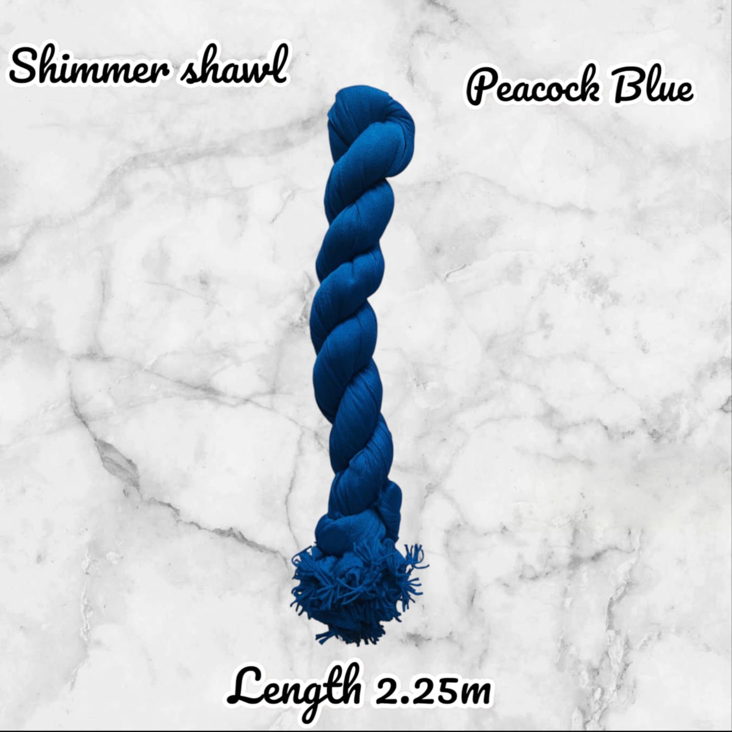 Blue yarn skein labeled 'Shimmer shawl Peacock Blue' on a marble background