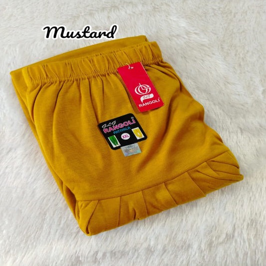 Mustard yellow shorts with a brand tag on a light background