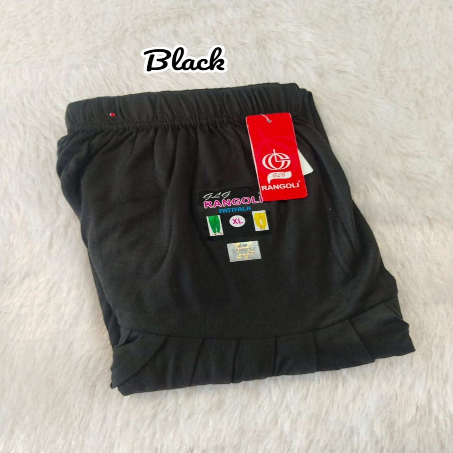 Black shorts with a red tag on a light gray background