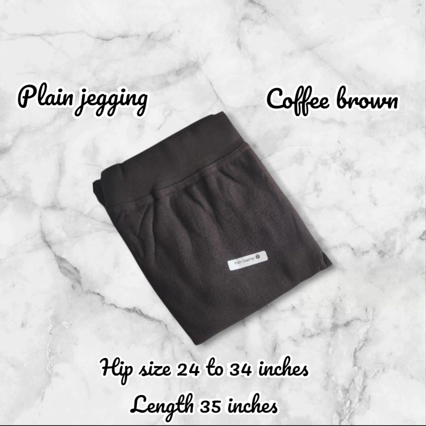 Folded black jegging on a marble surface with text indicating color, size range, and length.