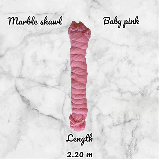 Pink yarn skein labeled 'Marble shawl' and 'Baby pink' on a marble background with length measurement.